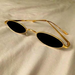 Small oval sunglasses with gold frame